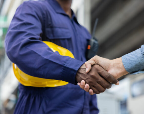 Construction workers shaking hands together